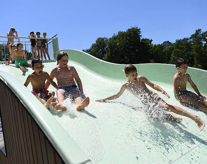 Kinder auf der Wasserrutsche.