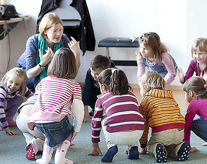 Kinder und Lehrerin bei musikalischer Früherziehunng